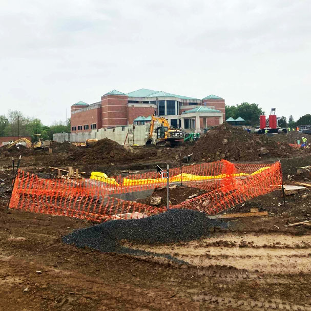 The south concrete wall of the GIB in the distance in front of Collins Hall. The south concrete wall of the GIB in the distance in front of Collins Hall.